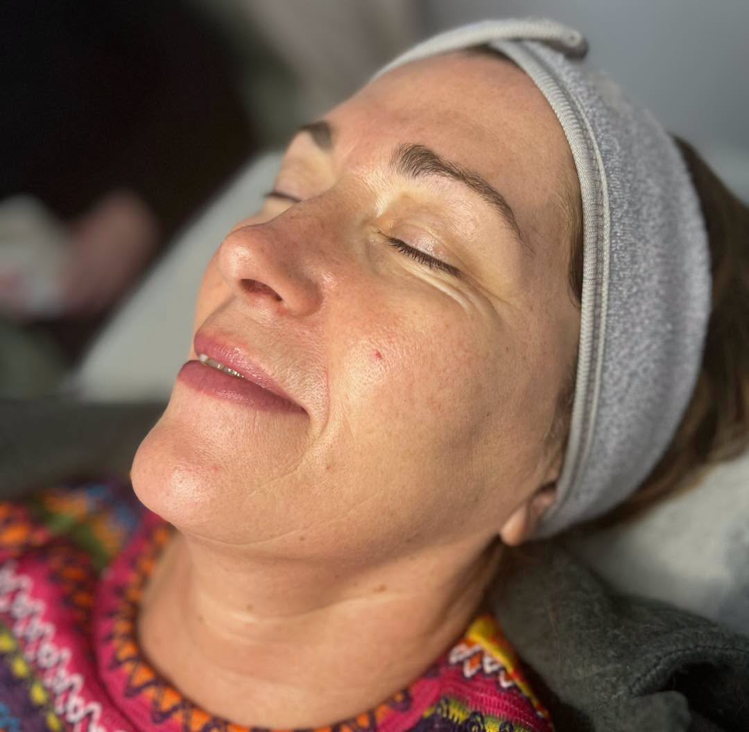 Client relaxing during a Tropic skincare facial at Bare Beauty by Jenny